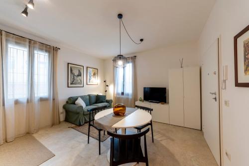 a living room with a table and a couch at HouSmart Montanara 606-2 in Vignola