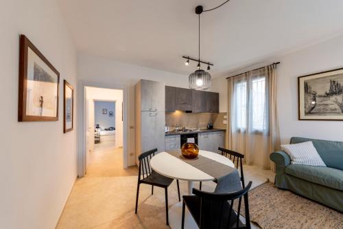 a kitchen and a living room with a table and chairs at HouSmart Montanara 606-2 in Vignola