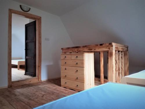 a bedroom with a dresser and a mirror at Chata Bachláč, Jarabá in Jarabá