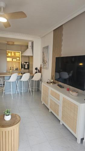 a living room with a large flat screen tv at Paradiso de Playa LaMata in La Mata