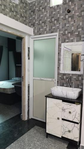 a bathroom with a sink and a mirror at Anand stay in Dānāpur