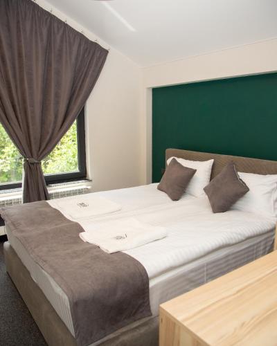 a large bed in a room with a window at Datcha Tsaghkadzor in Tsaghkadzor