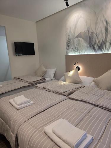 a bedroom with two beds with towels on them at Pension Oasis Alicante in Alicante