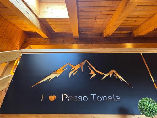 a sign for paso taho tamale on a wall at Dinastia Case Snow Apartment in Passo del Tonale