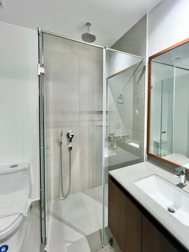 a bathroom with a shower and a toilet and a sink at Seis Residences in Quito