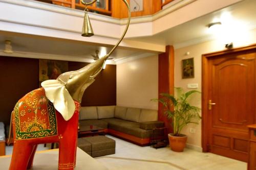 a statue of an elephant sitting in a living room at FabHotel Pink Cozzy in Jaipur