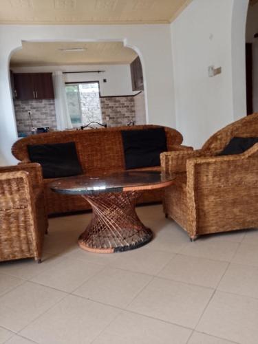 a living room with a table and two chairs at majaoni villa in Mombasa
