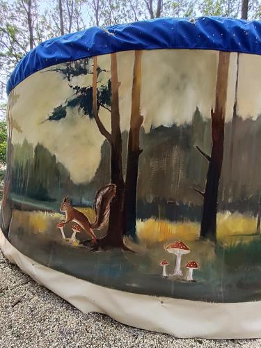 a painting of a forest with a squirrel and mushrooms at Jurta Na Skraju Lasu in Zawady