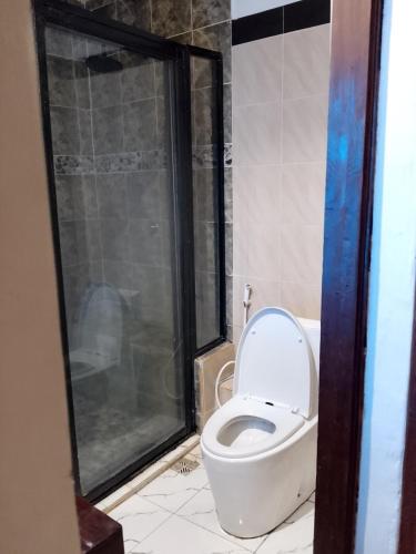 a bathroom with a toilet and a shower at majaoni villa in Mombasa