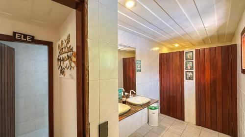 a bathroom with a sink and a toilet at The Eco Palace Hostel in Búzios