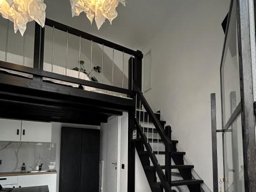 a loft bed with a staircase in a room at NEKTAR home in Latsídha