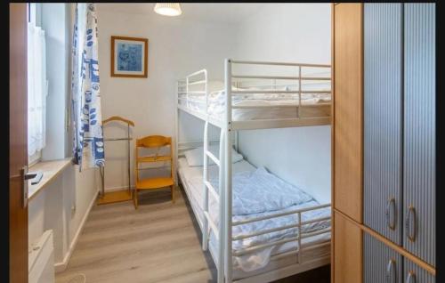 a bunk bed room with two bunk beds in it at Ferienwohnung Seesternchen am Deich2 C46 in Norden