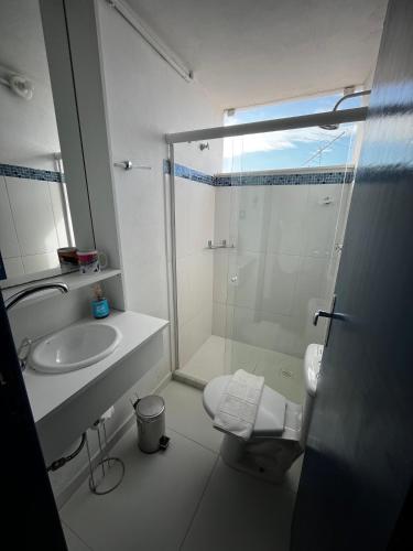 a bathroom with a shower and a toilet and a sink at Casa igba in Rio de Janeiro