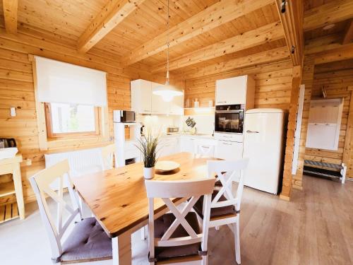 a kitchen and dining room with a wooden ceiling at Ferienhaus Ostseeperle in Biendorf