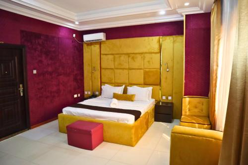 a hotel room with a bed and a couch at ZiZi BY KDOVE HOTLES AND SUITES in Ikeja
