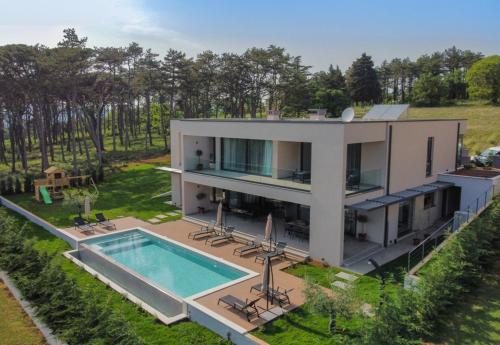 an aerial view of a house with a swimming pool at Villa Valpinia Luxury Villa in a Quiet Location with Pool, Sauna, Jacuzzi and Large Garden in Martinski