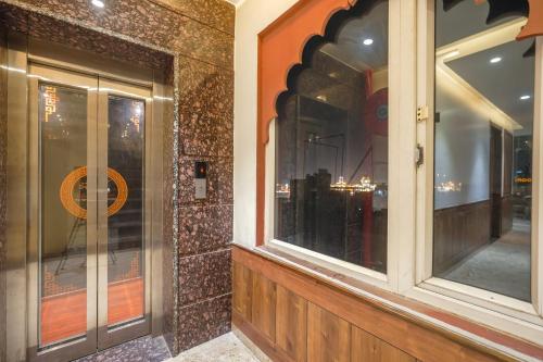 een etalage van een winkel met een reflectie erin bij HOTEL RV GOLDEN 50 MTR FROM Golden temple in Amritsar