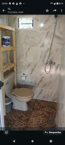 a bathroom with a toilet and a shower at Lo de Benja in Agote