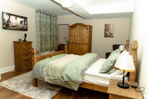 a bedroom with a bed and a table with a lamp at The Sycamore Inn in Birch Vale