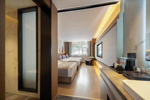 a hotel room with a bed and a bathroom at 张家界民宿 in Hanqiyu