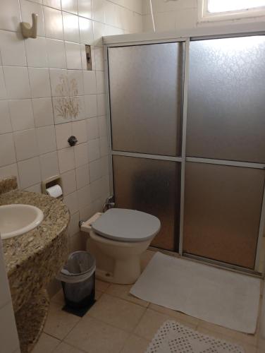 a bathroom with a shower and a toilet and a sink at Mini Hostel Fine Art in Vitória da Conquista