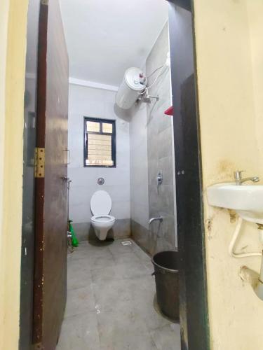 a bathroom with a toilet and a sink at Shree Sairam Pg For Gents in Pune