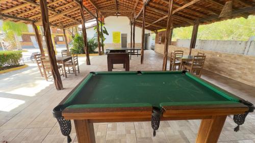 a pool table in a pavilion with tables and chairs at NLC locações BonsVentos in Barreirinhas