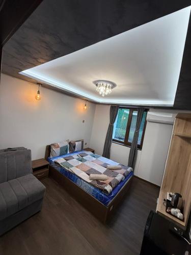 a bedroom with a large bed in a room at Guest House MARAVILA in Belogradchik