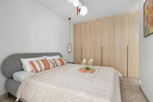 a bedroom with a large bed with a tray on it at Unique Studio with Parking Space and Swimming Pool by Noclegi Renters in Pobierowo