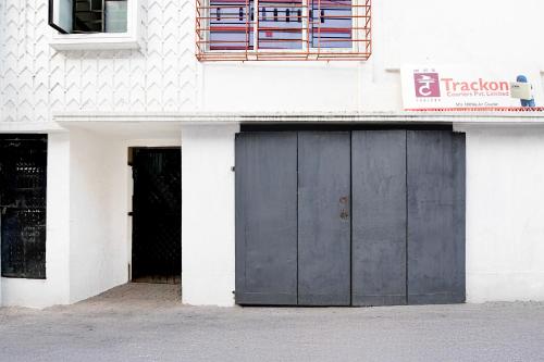 a building with two garage doors on the side of it at FabHotel Rajdanga Retreat in Kolkata