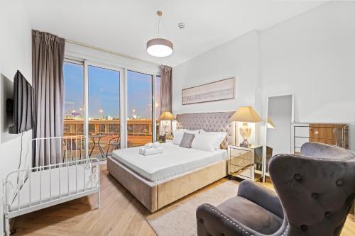 a bedroom with a bed and a balcony at Contemporary 1BR City View Apartment at 1 Residence in Dubai