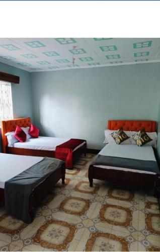 a room with two beds in a room at Nanja Mara Lodge in Masai Mara