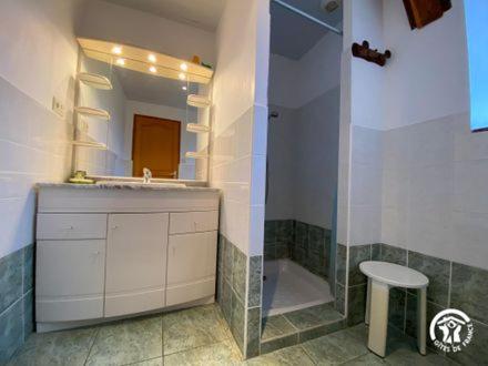 a bathroom with a sink and a mirror and a stool at le Chouette in Saint-Cyprien-sur-Dourdou
