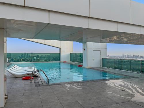 a swimming pool on top of a building at Contemporary 1BR City View Apartment at 1 Residence in Dubai
