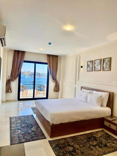 a bedroom with a bed with a view of the ocean at Nile Castle in Luxor