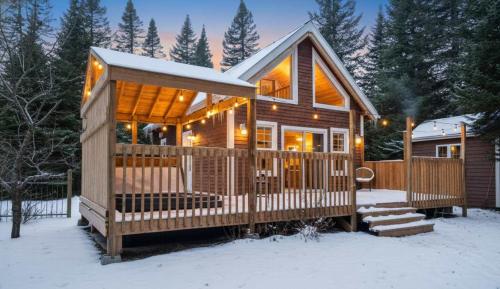 a wooden cabin with a porch in the snow at Nature & Spa - Sherwood in Valcartier Station