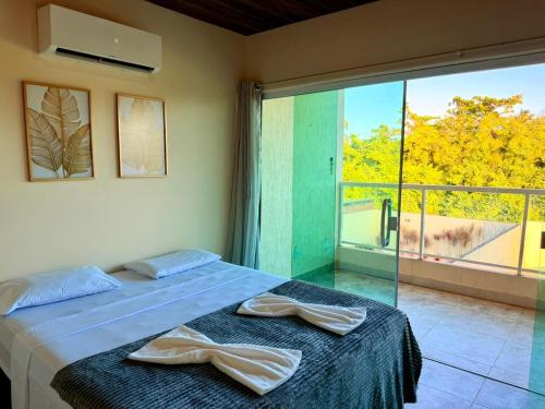 En eller flere senge i et værelse på Casa de Temporada 3 Quartos - Coruripe AL