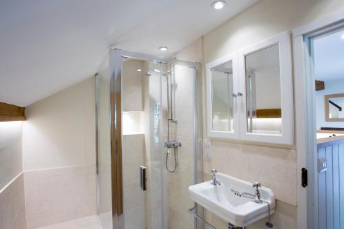 a bathroom with a sink and a shower at The Stables at Boreham House in Herstmonceux