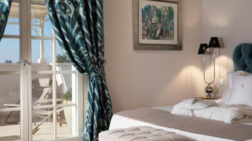 a room with a bed and a window and a chair at Luxury villa Adele with pool in Porec in Vabriga