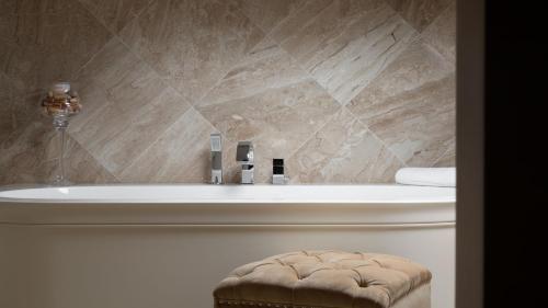 a bathroom with a bath tub and a toilet at Luxury villa Adele with pool in Porec in Vabriga