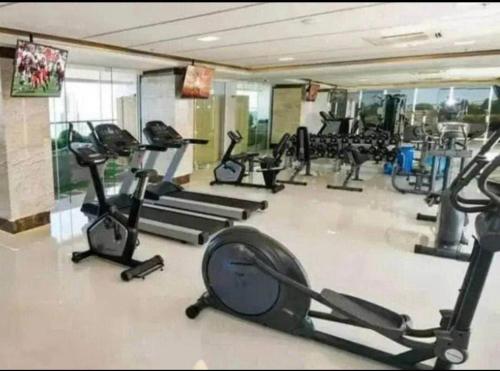 a gym with several treadmills and exercise bikes at Sea View Studio in Pattaya South