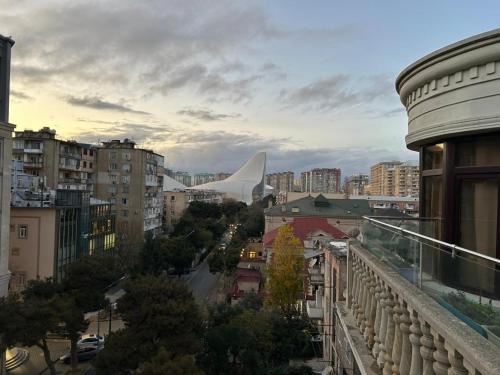 a view of a city from a balcony with a building at Luxury City Apartments in Baku