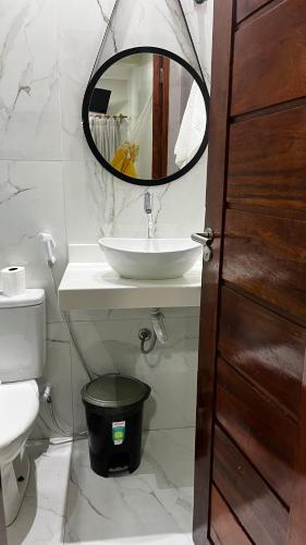 a bathroom with a sink and a mirror at Central Flats Jeri in Jericoacoara