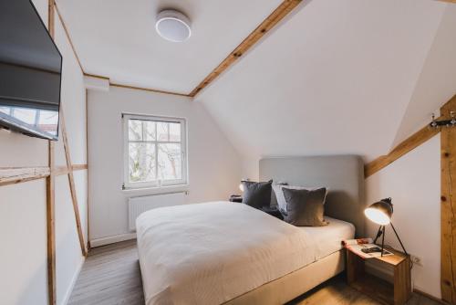 a bedroom with a large bed and a window at Harzlodge Emma in Braunlage