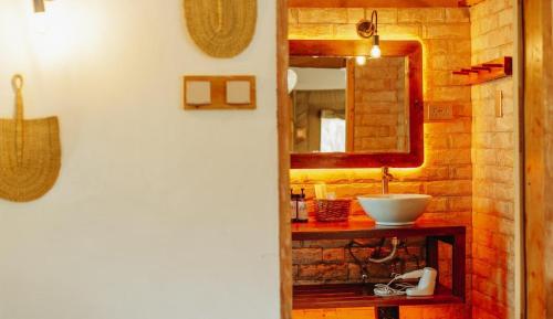 a bathroom with a sink and a mirror at Kipekee Zuri Camp in Ololaimutiek