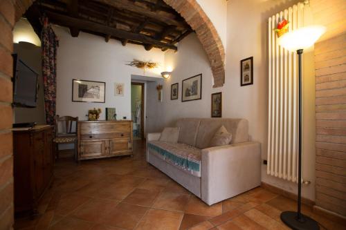 a living room with a couch and a dresser at Antica Fonte Residenza di Siena in Siena