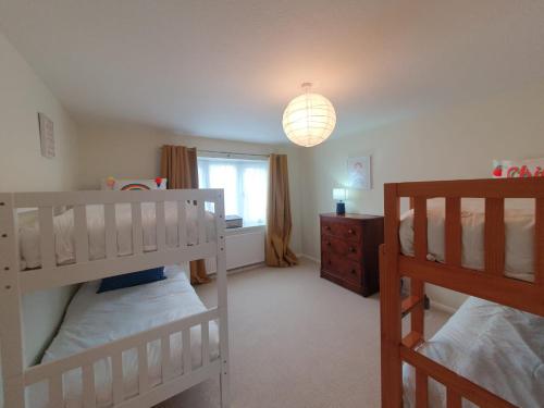 a bedroom with two bunk beds and a window at Family Seaside Bungalow - Max 6 Adults Only in Margate
