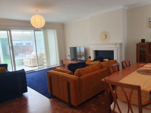 a living room with couches and a table and chairs at Family Seaside Bungalow - Max 6 Adults Only in Margate