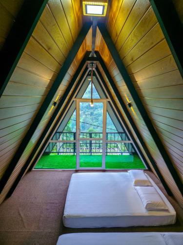 a bed in a room with a window at White Moon Cabin & Cottage in Ella