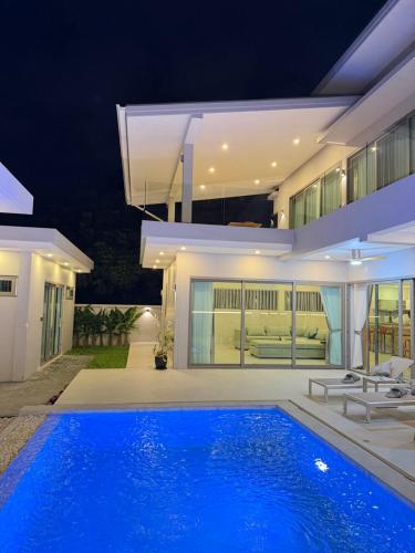 a house with a swimming pool at night at CH Villa Travertine Stone in Ko Samui